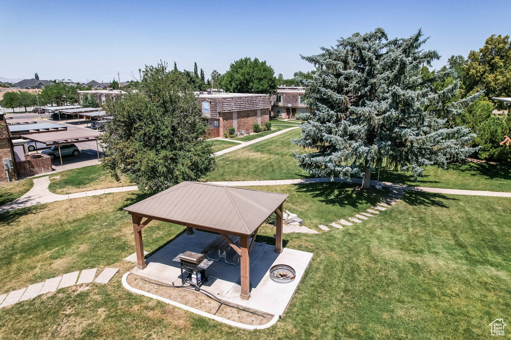 Surrounding community with a gazebo, a lawn, and a patio
