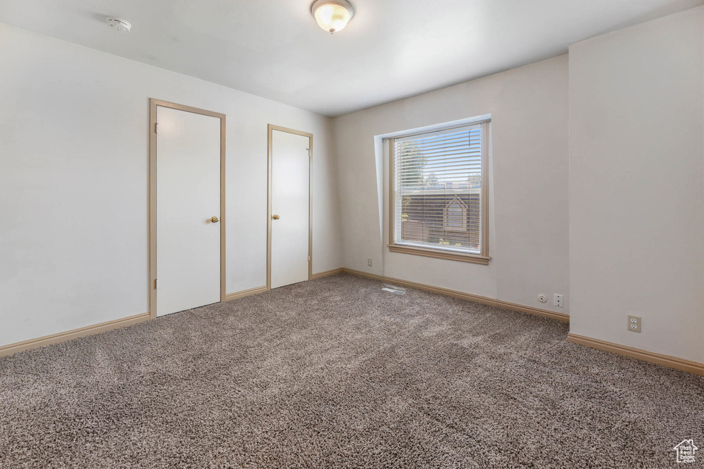 Unfurnished bedroom with carpet