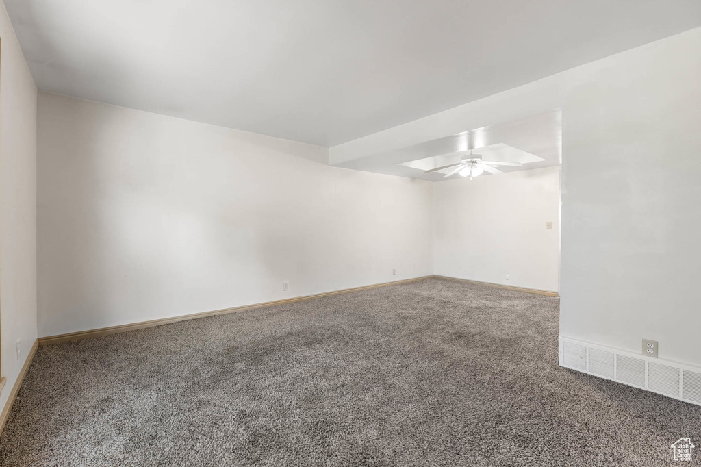 Empty room with carpet and ceiling fan
