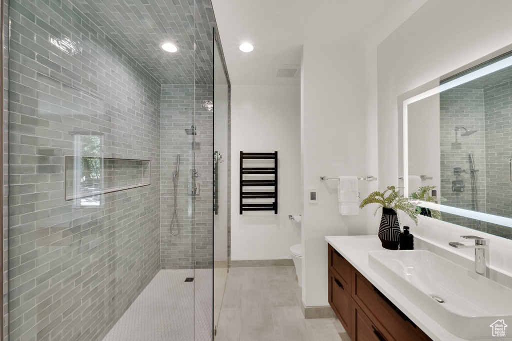 Bathroom with vanity, a shower stall, recessed lighting, and tile patterned flooring