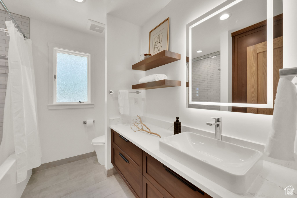 Full bathroom featuring vanity, recessed lighting, tile patterned flooring, and shower / bath combo