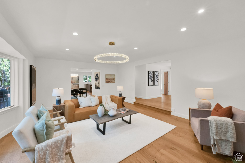 Living room featuring light wood finished floors, recessed lighting, and a chandelier