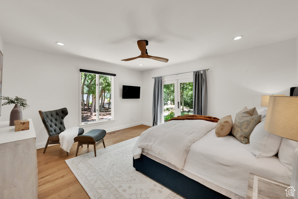 Bedroom with multiple windows, light wood-type flooring, recessed lighting, and ceiling fan