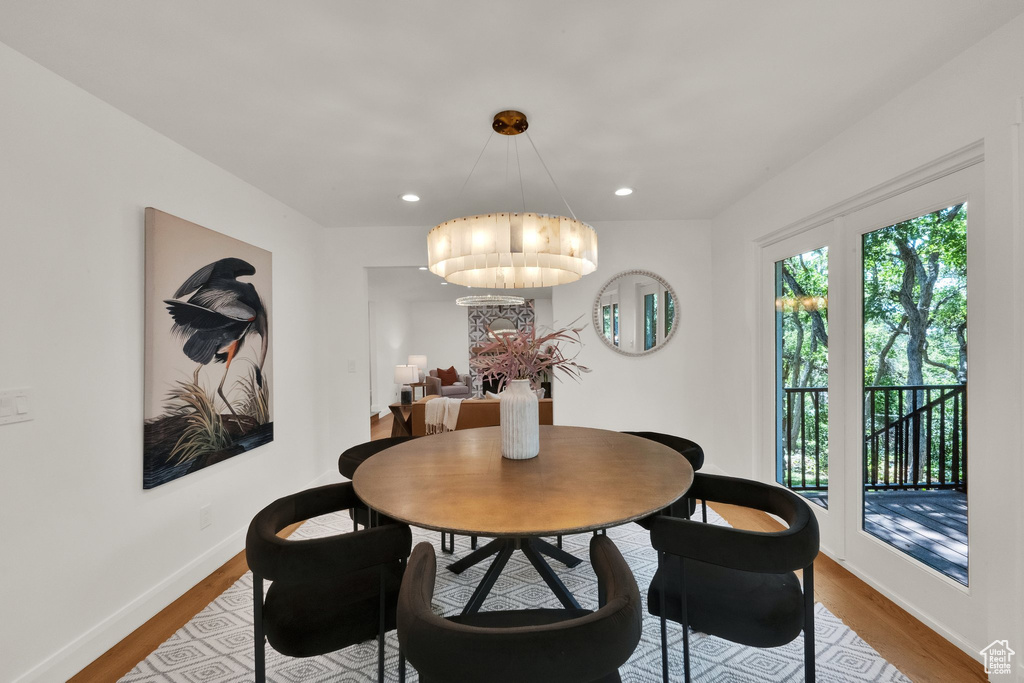 Dining space featuring a chandelier, wood finished floors, and recessed lighting