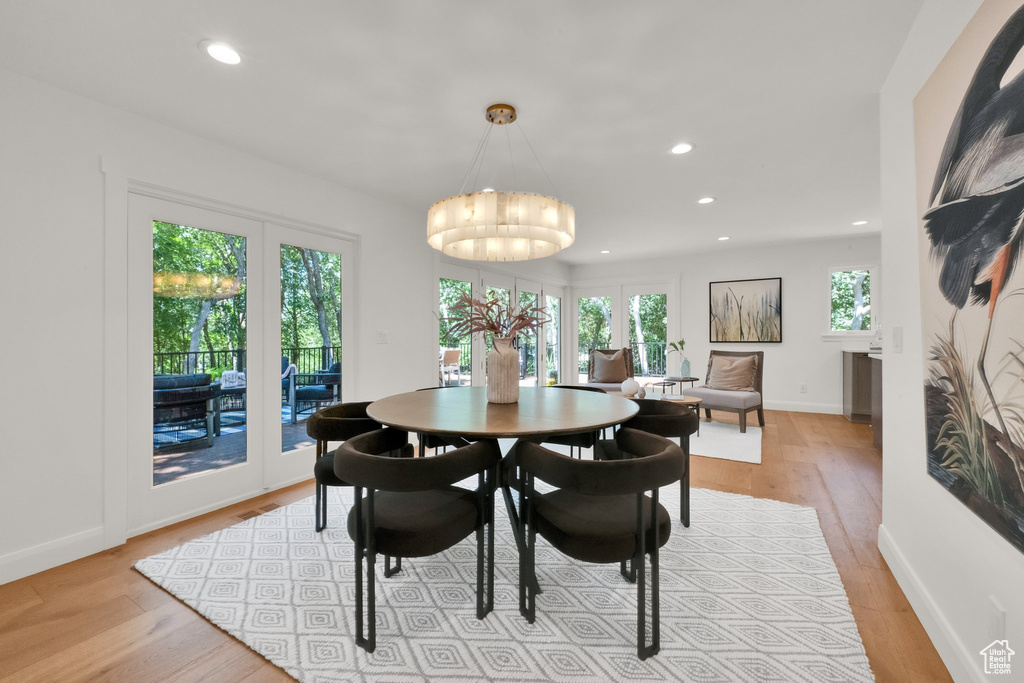Dining room featuring recessed lighting, light wood-style flooring, a chandelier, and french doors