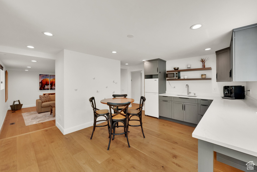 Dining area featuring light wood finished floors and recessed lighting
