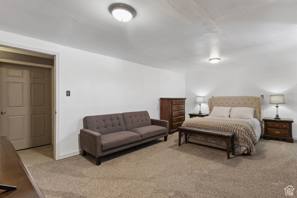 Carpeted bedroom featuring baseboards