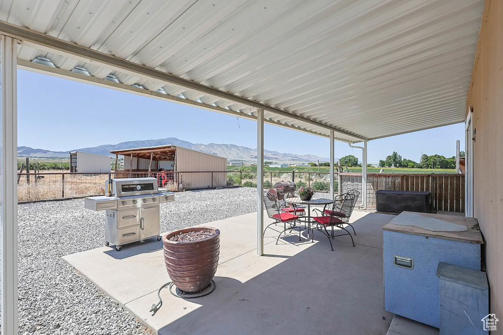 View of patio / terrace with a mountain view and outdoor dining space