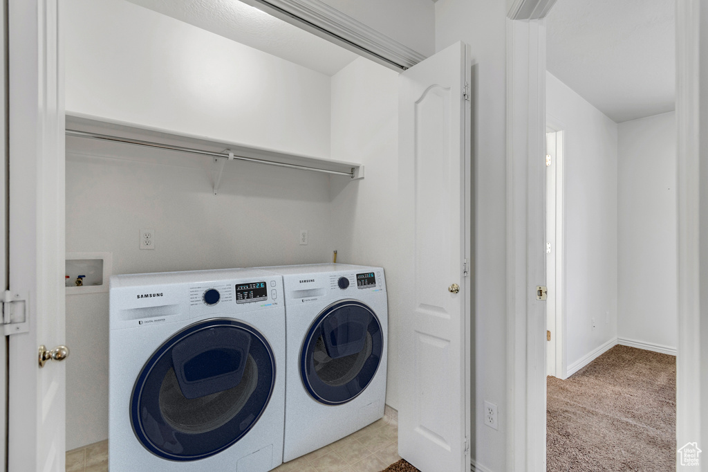 Laundry room with washer and clothes dryer