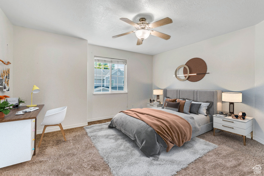Bedroom with carpet flooring, a textured ceiling, and a ceiling fan