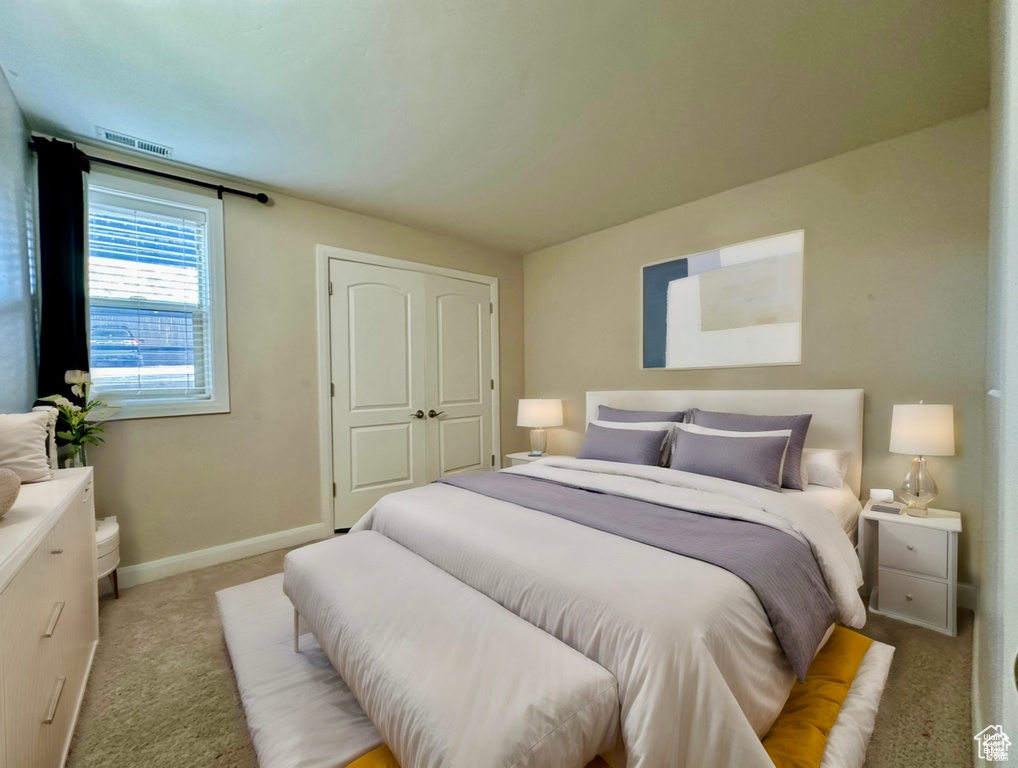 Bedroom featuring light carpet and baseboards