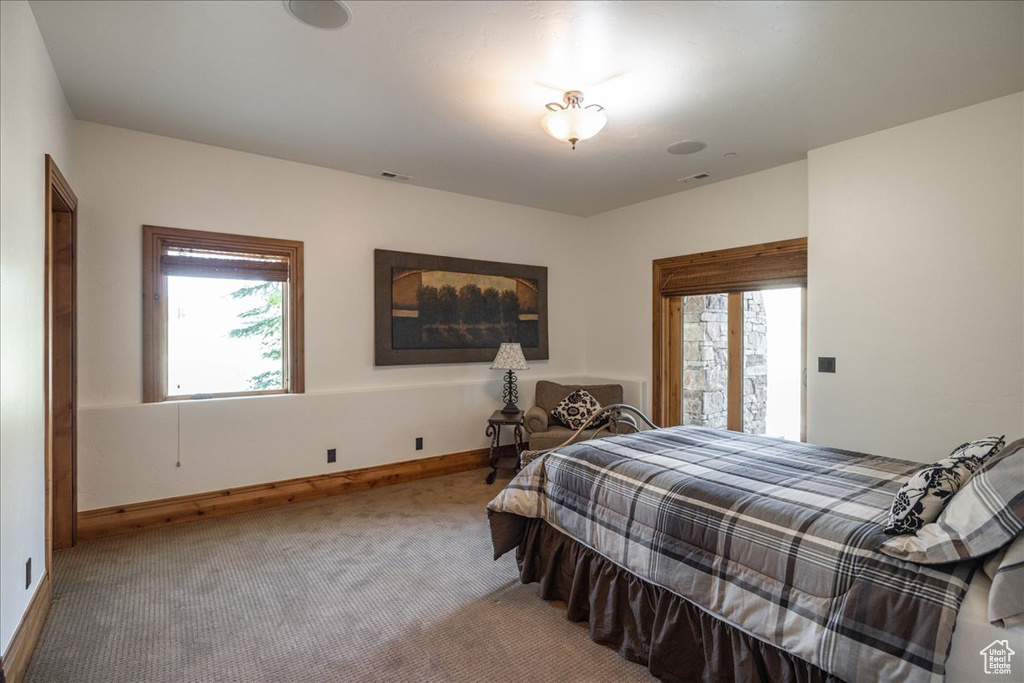 Bedroom featuring carpet and baseboards