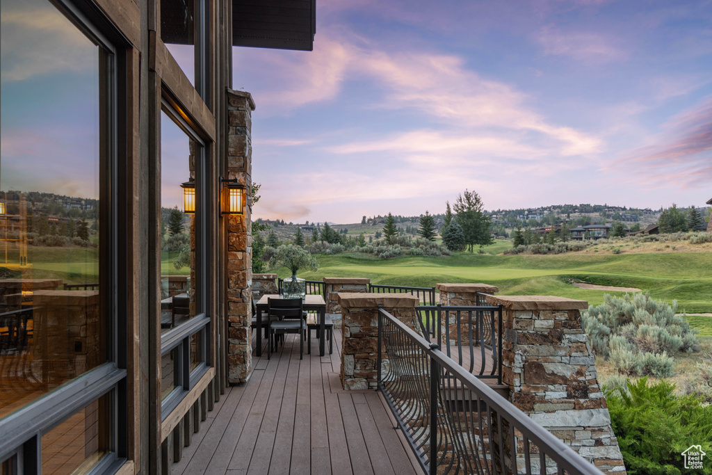 Deck featuring outdoor dining space and golf course view