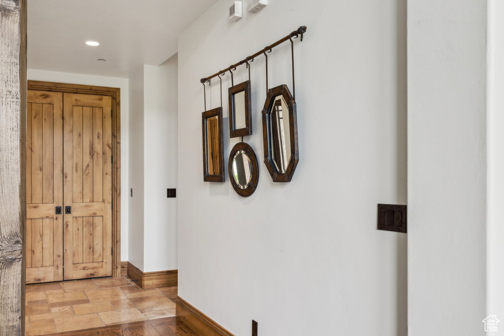 Hallway with recessed lighting and baseboards