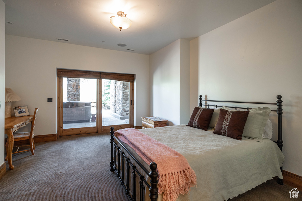 Bedroom with access to outside and carpet