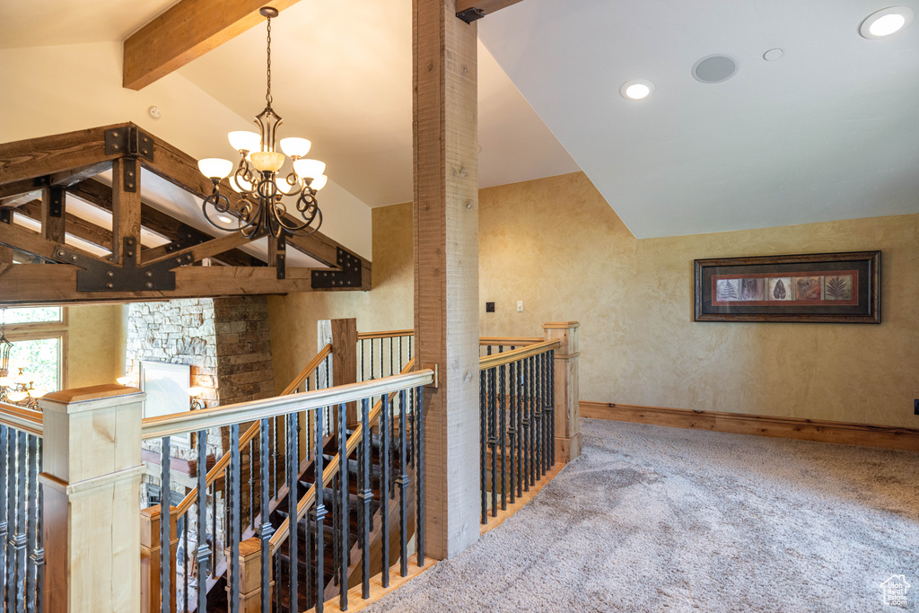 Corridor with an upstairs landing, carpet, a chandelier, and recessed lighting