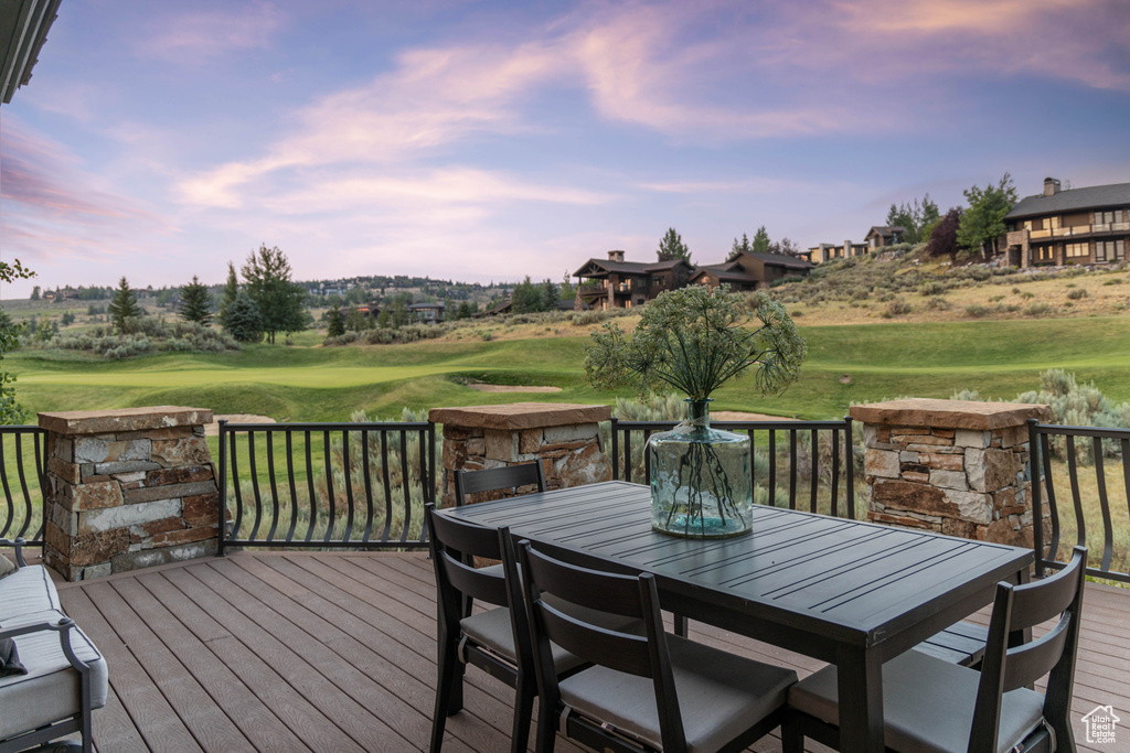 Deck featuring outdoor dining area and golf course view
