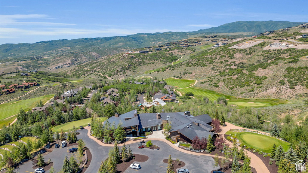 View of property location with a local golf course, a mountain backdrop, and nearby suburban area