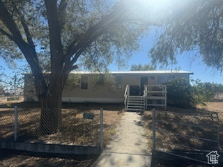 View of front of home featuring a fenced front yard and a gate