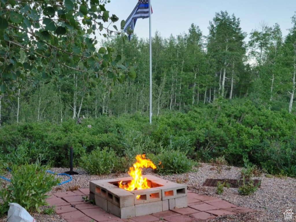 View of yard with a fire pit and a patio
