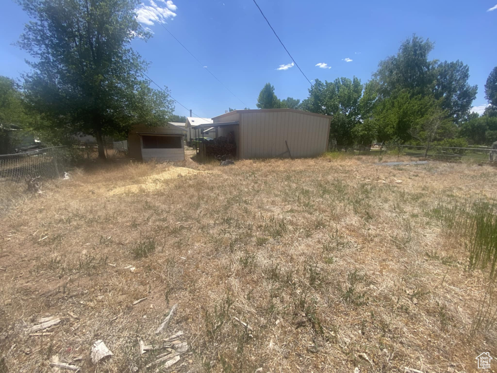 View of yard with an outbuilding and a pole building