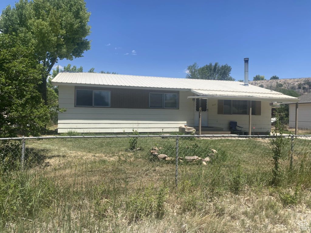 Rear view of property featuring a metal roof