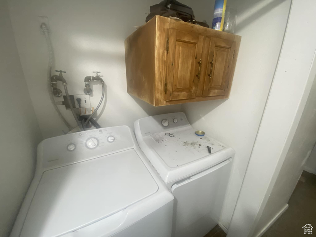 Laundry room with cabinet space and washer and clothes dryer