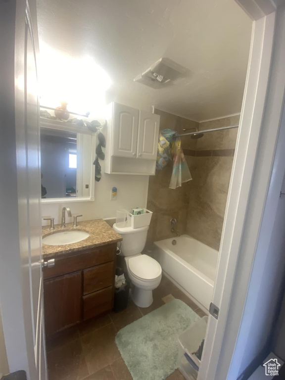 Bathroom featuring vanity, bathing tub / shower combination, and tile patterned floors