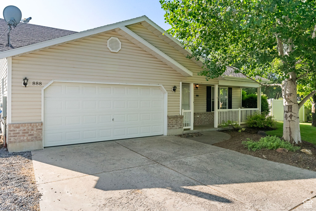 Ranch-style house featuring brick siding, a porch, concrete driveway, a garage, and roof with shingles