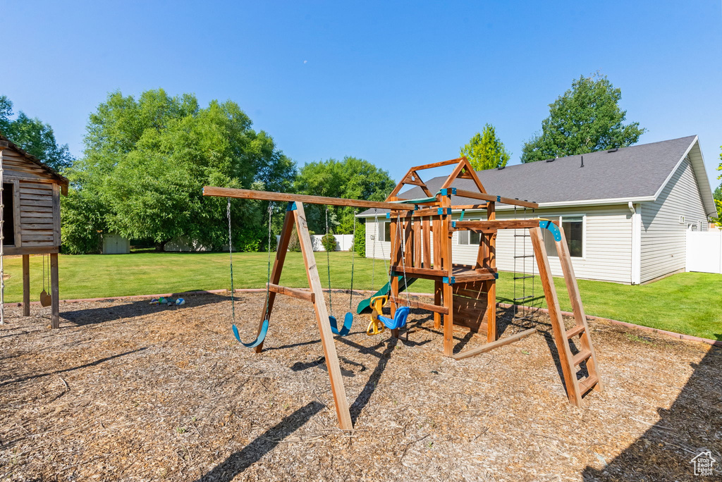 View of jungle gym featuring a lawn