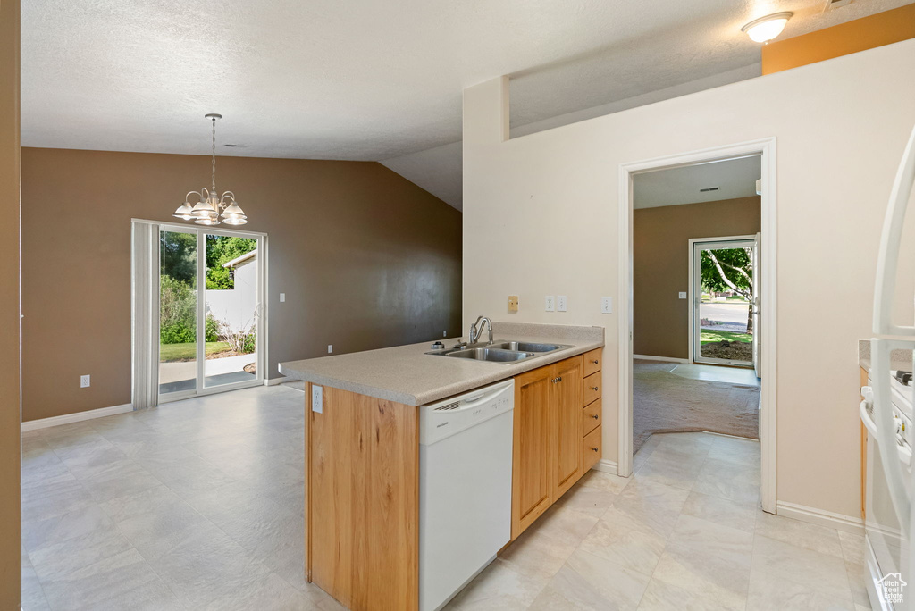 Kitchen featuring white dishwasher, light countertops, hanging light fixtures, a chandelier, and light brown cabinets