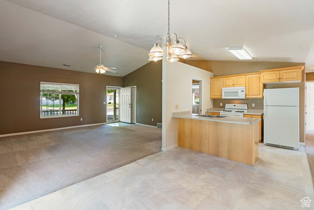 Kitchen with white appliances, lofted ceiling, ceiling fan, open floor plan, and light countertops