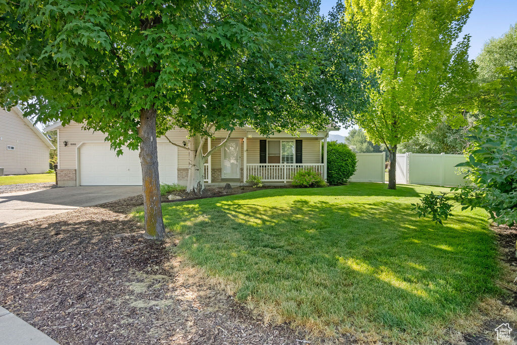 Obstructed view of property featuring covered porch and driveway