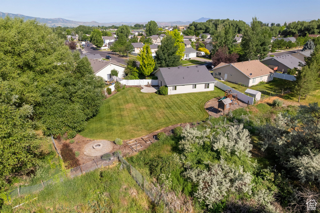 Aerial view of property and surrounding area with nearby suburban area