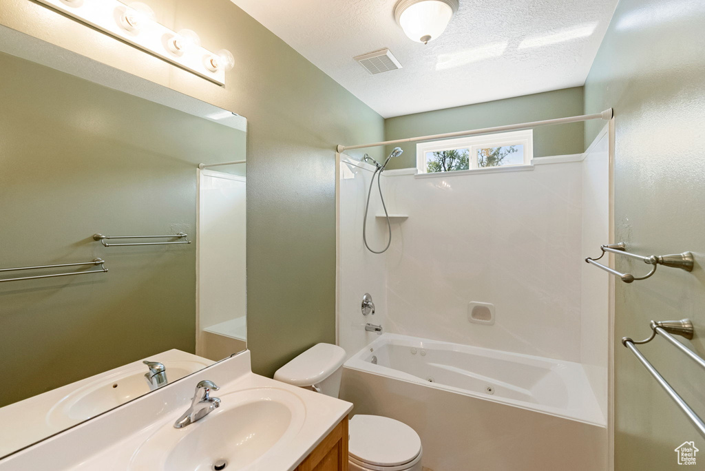 Full bathroom featuring a combined bath / shower with jetted tub and vanity