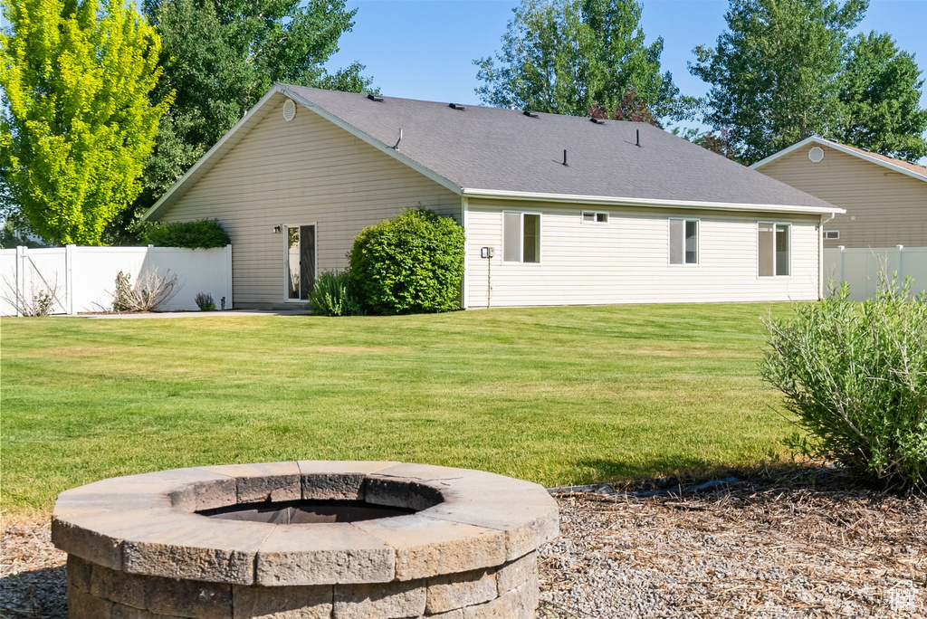 Rear view of house with a fire pit