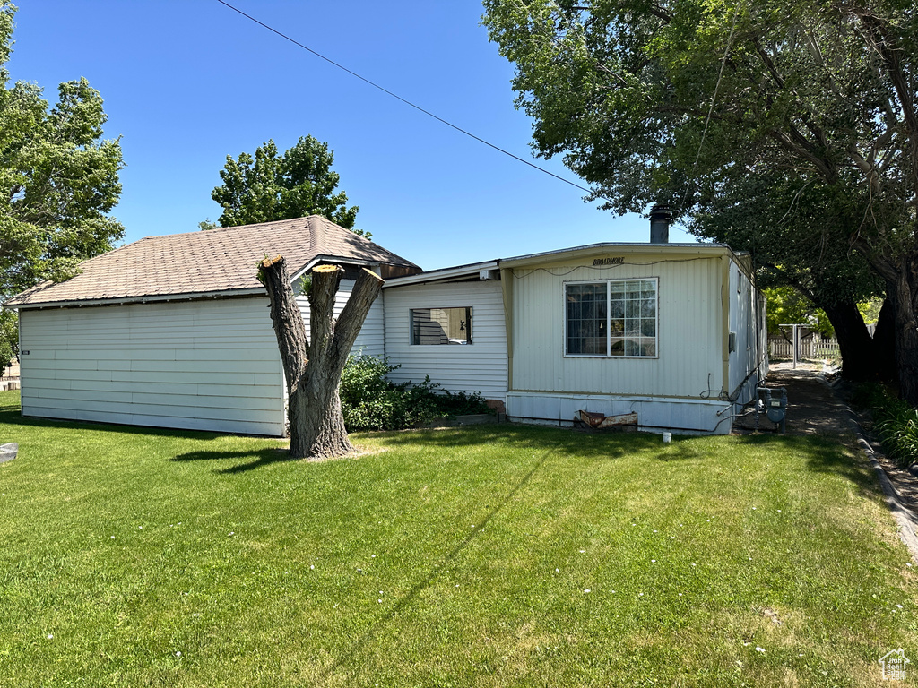 Rear view of property with a lawn
