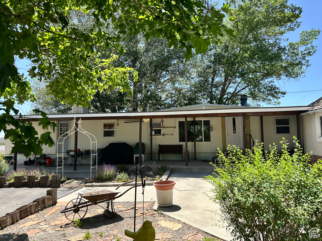Rear view of house featuring a patio area