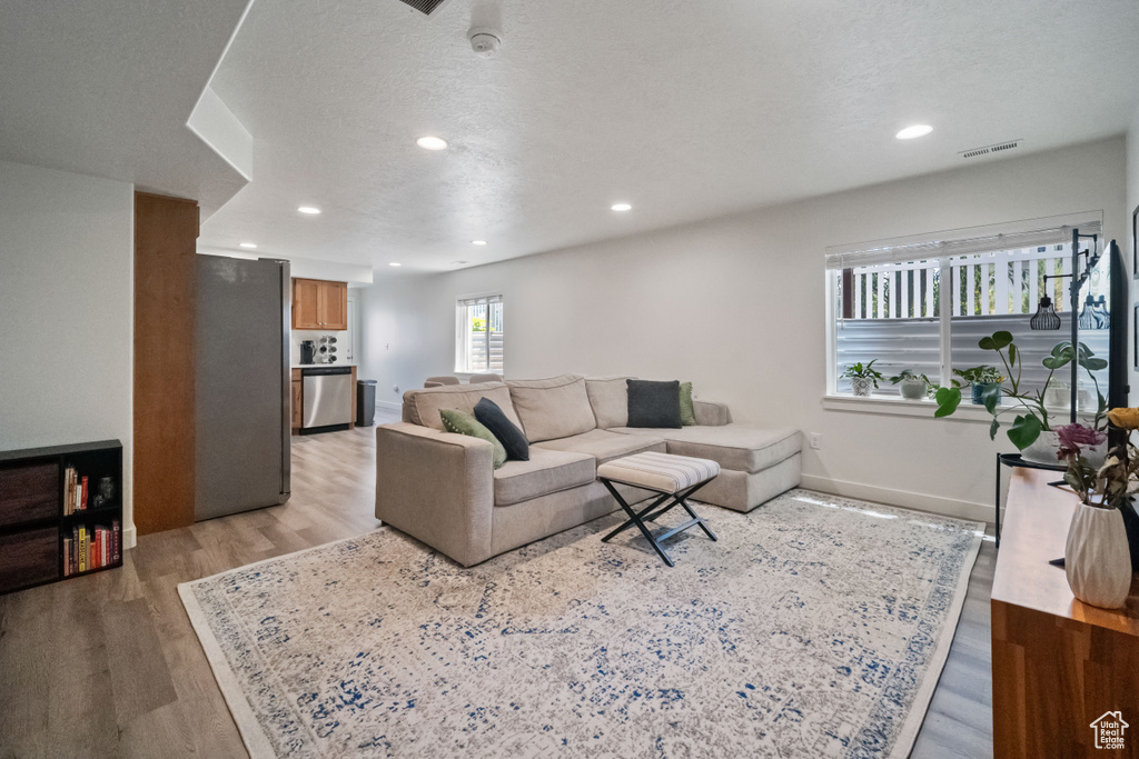 Living room featuring light wood-style floors and recessed lighting