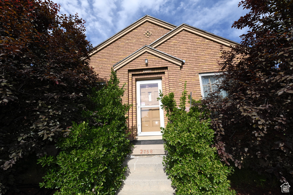 View of front facade featuring brick siding