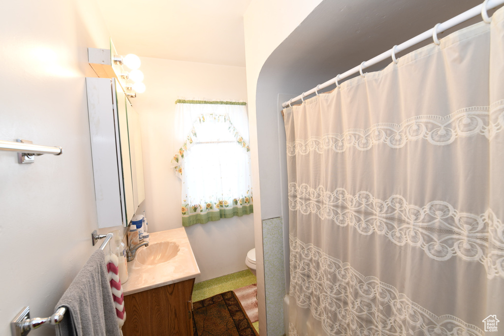 Full bathroom with vanity and curtained shower
