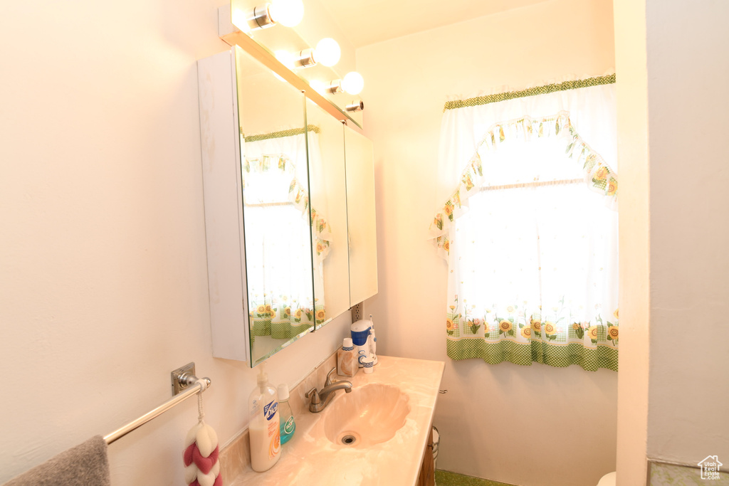 Half bath with vanity and toilet