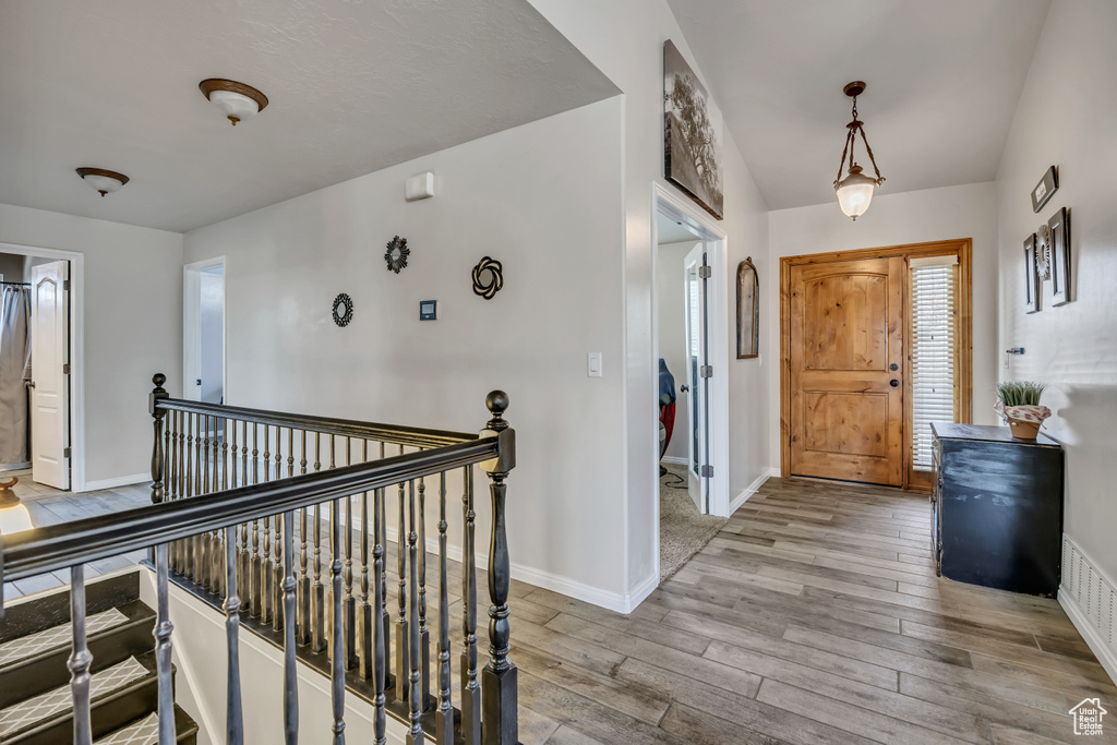 Foyer entrance featuring wood finished floors and baseboards