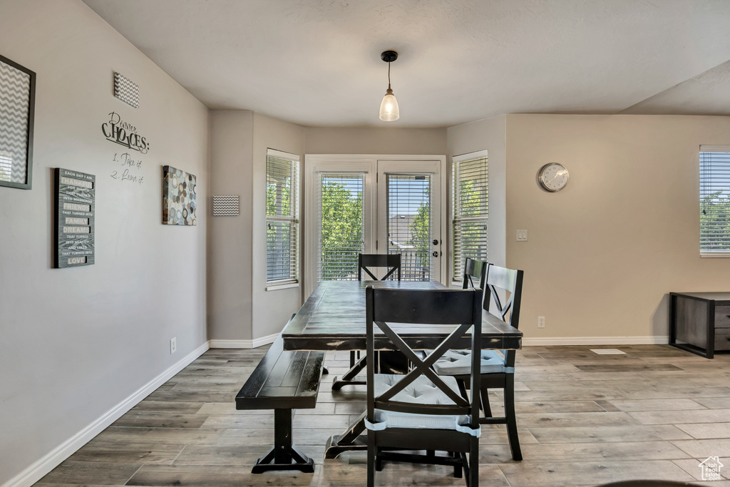 Dining area with wood finished floors and healthy amount of natural light