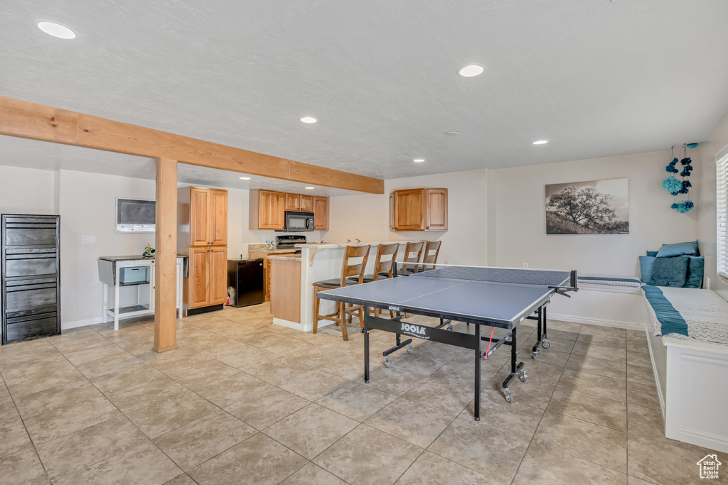 Game room with recessed lighting and light tile patterned floors