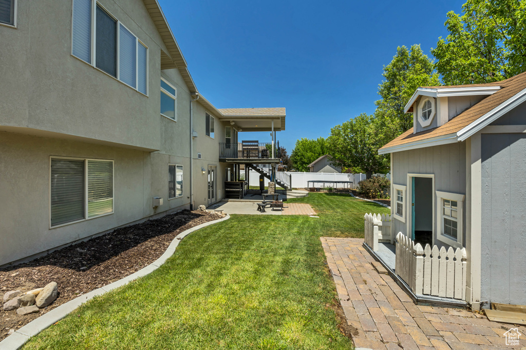 View of yard featuring a patio, a balcony, and stairway