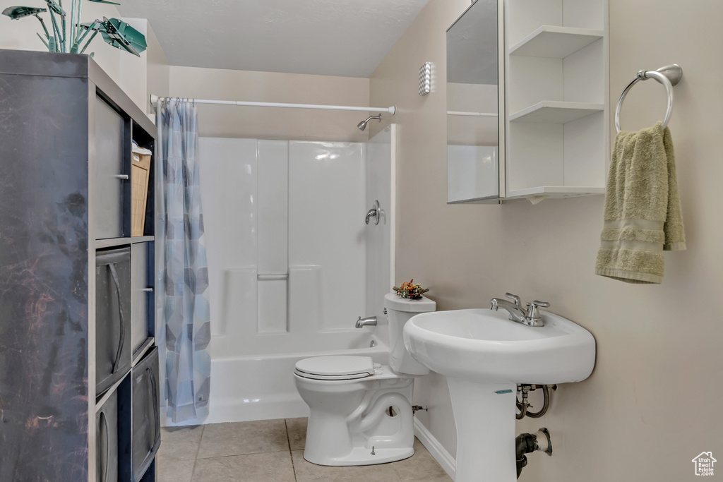 Full bathroom with shower / bath combo and tile patterned flooring