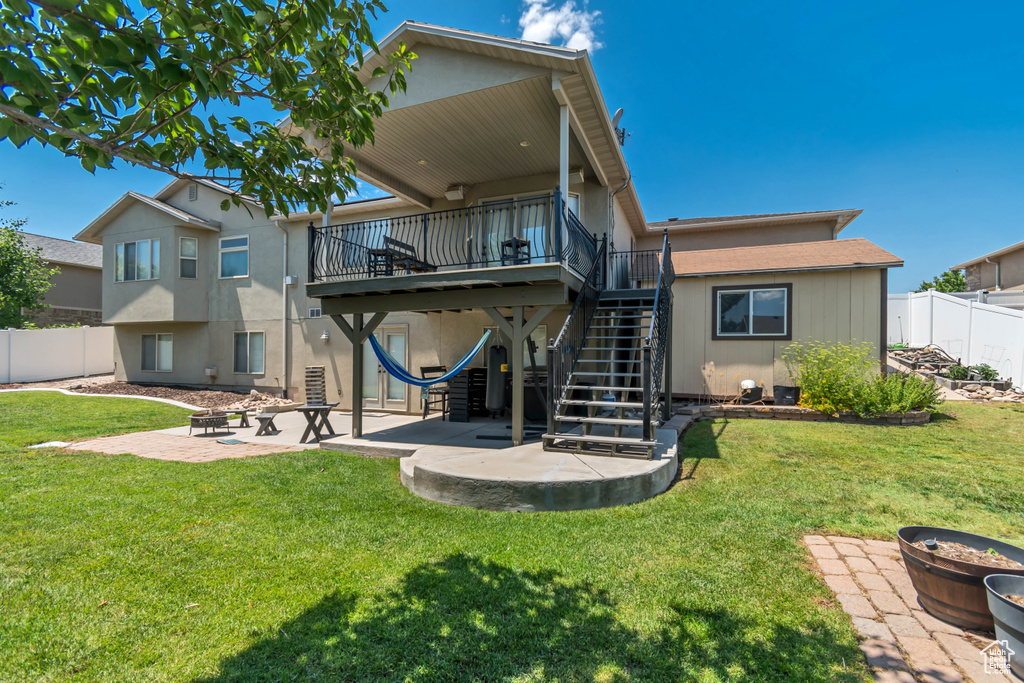 Rear view of house with a patio, stairway, a deck, and a fenced backyard
