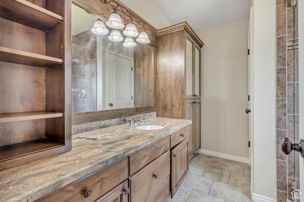 Full bath featuring vanity and stone finish floors