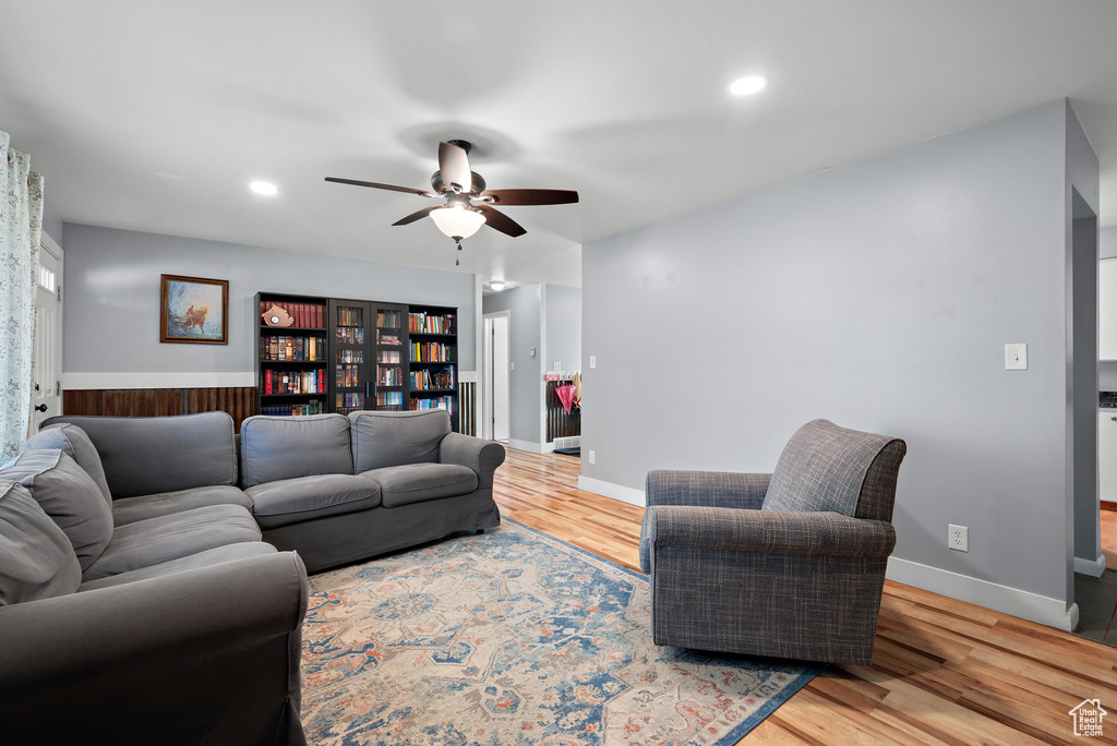 Living room with ceiling fan, wood finished floors, and recessed lighting